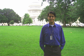 Brian Eagan stands atop a grassy knoll by the Capitol