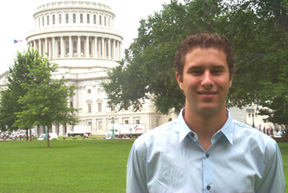 Mike Haley-Gritzbaugh standing in a grassy area in front of the Capitol