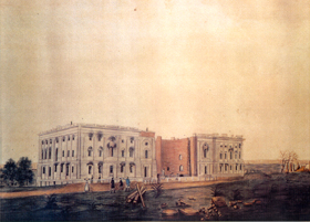 This watercolor painting presents a tan, bleak sky draped behind the recently burned Capitol building. The two wings of the Capitol still stand. The dome had not yet been built. Black, smokey soot lines each window and four people appear worried in the foreground.