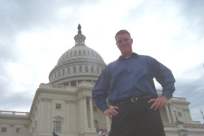 Andrew Black standing on the Capitol staris with the Capitol dome in the background