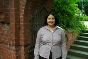 Angelica Rubio standing in front of a red brick structure