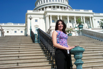 A photo of intern Divina Chavez, who is leaning against a bannister outside the Capitol. Behind her, a long flight of marble steps leads to the Capitol dome.