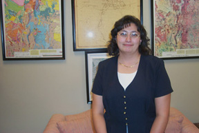 Michelle Carillo stands in front of maps in Senator Bingaman's office.