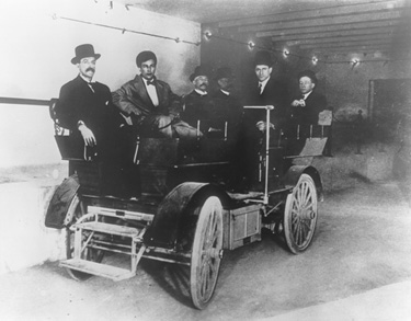 Several senators travelling on an early subway car.